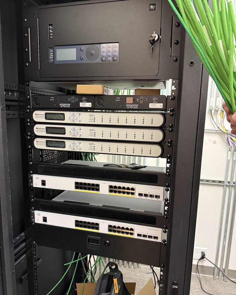 Performance venue rack with ETC DMX gateways, Pathway opto-splitters and Cisco switches
