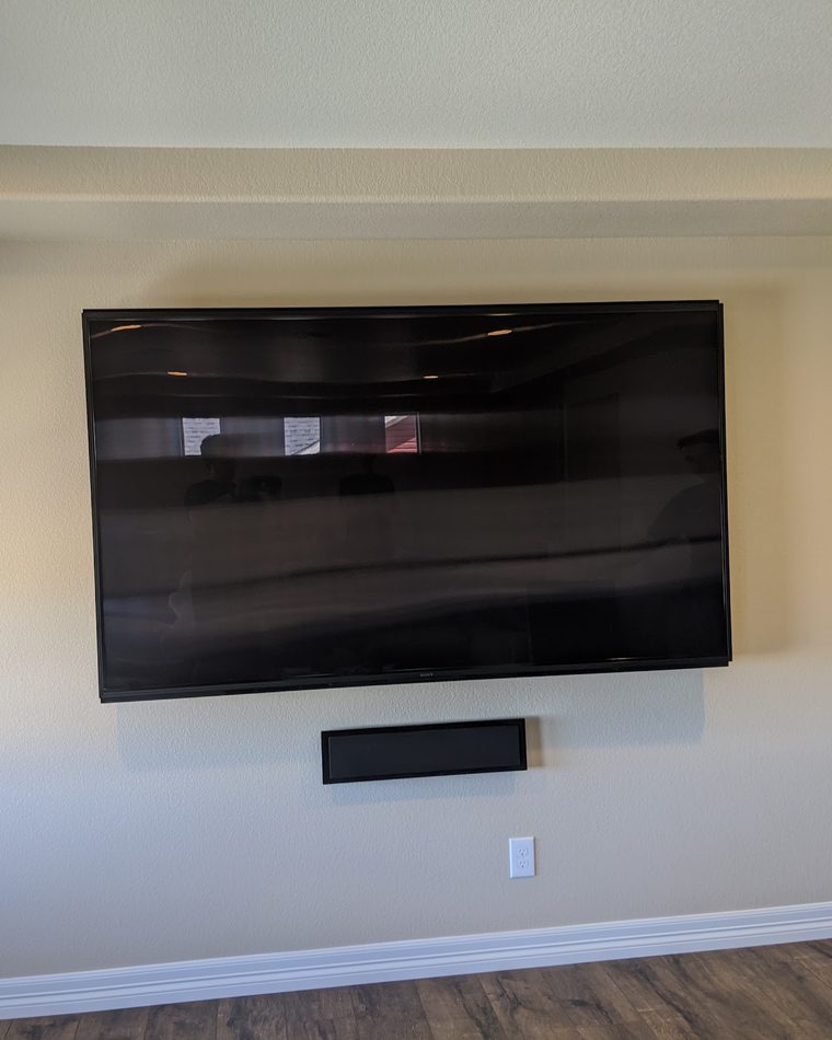 Wall-mounted display flanked by in-wall left, center and right loudspeakers